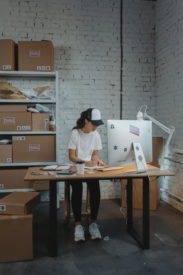 Worker packing connector orders at a desk